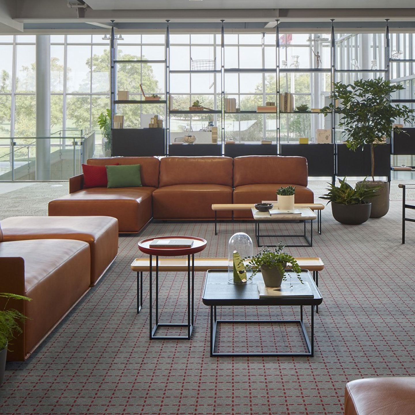 Haworth Torei table in natural ask and red stained ash in an office lobby area with plants and leather couches