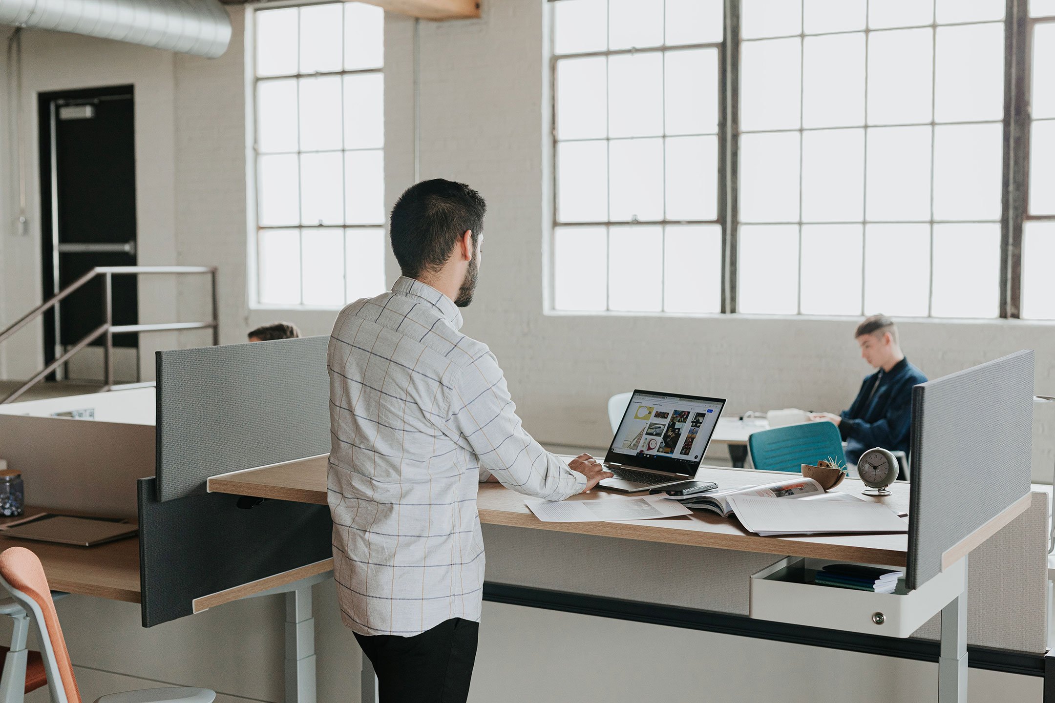 Haworth Upside Height Adjustable Table being used in as an office workspace in a casual office area