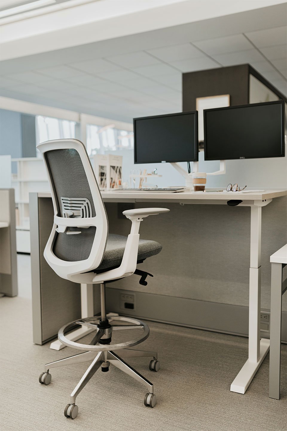 Haworth Upside Height Adjustable Table being used as an office work space desk with two monitors and a haworth chair