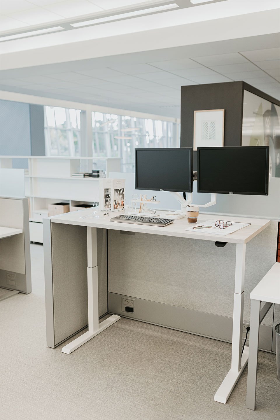 Haworth Upside Height Adjustable Table being used as an office work space desk with two monitors and a haworth chair