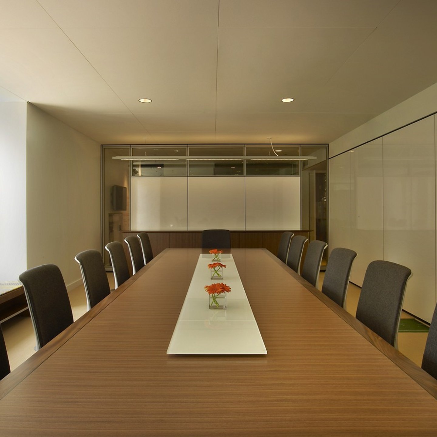Haworth Wood Conference table in conference room with glass walls and flower centerpeice