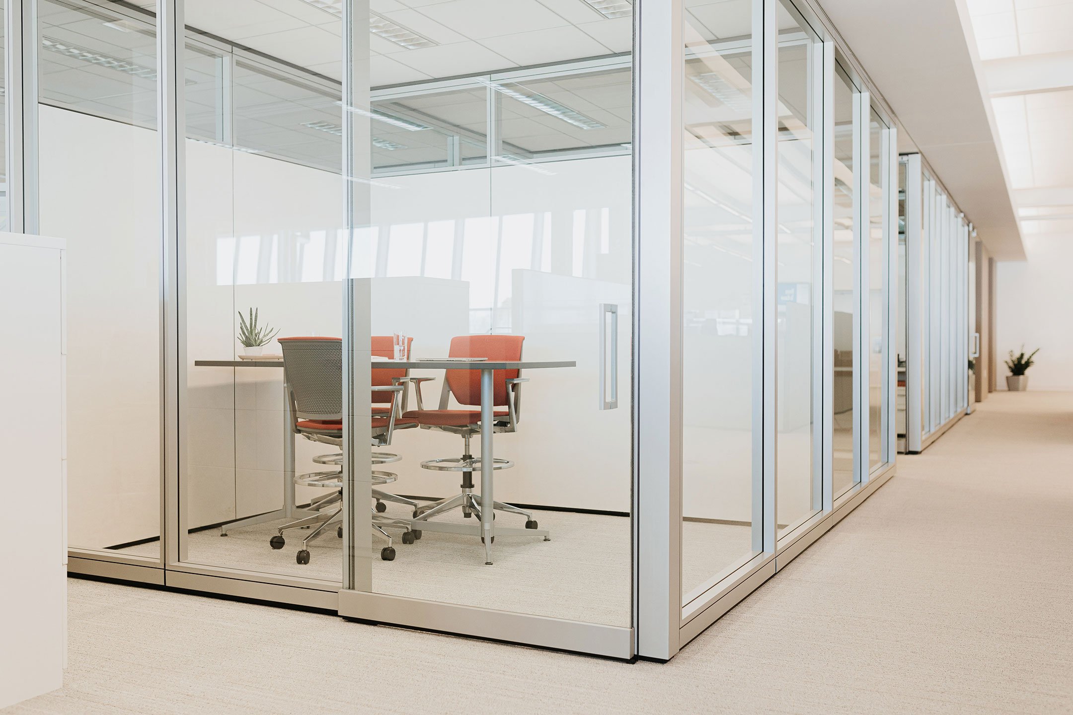 Haworth Enclose Wall in office space for private work spaces with red chairs and desks