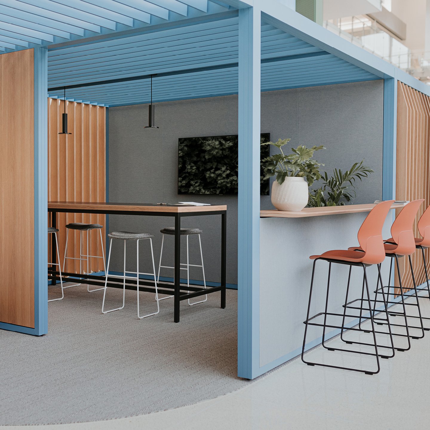 Haworth Pergola Workspace with blue trim and blue walls with tall table and chairs for collaboration in an open office space
