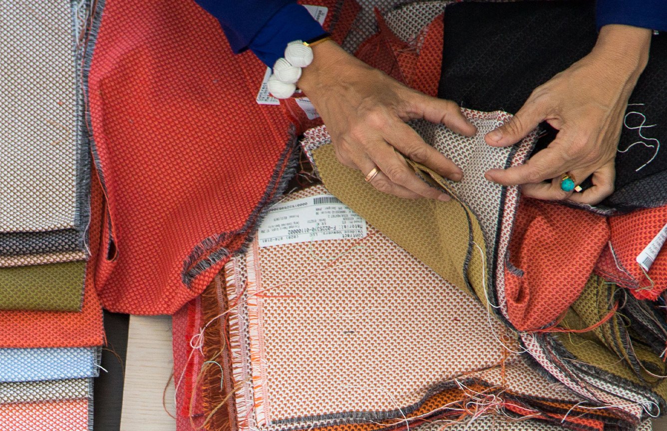 Designer flipping through fabric swatches