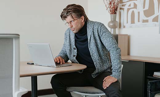 Haworth The Fireworks Economy Spark Employee at conference table in conference room on grey chair