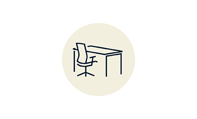 Graphic icon representing a work station with chair and desk