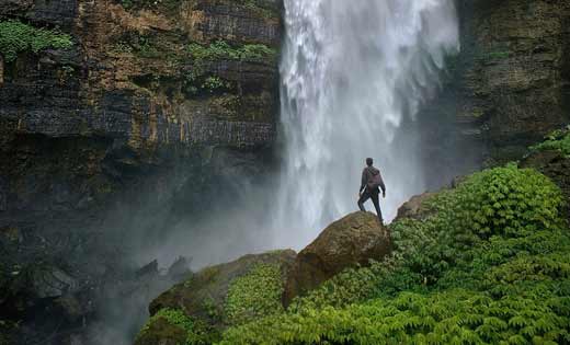 Haworth Biophilic Sound Spark waterfall with grass on the rocks and someone standing on rocks