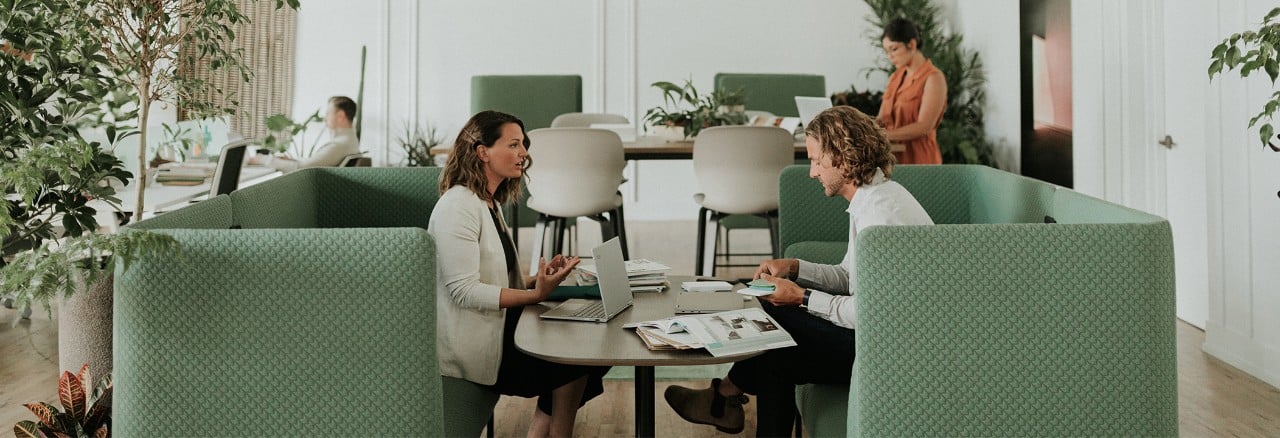 Man and woman conversing in multi-use office space